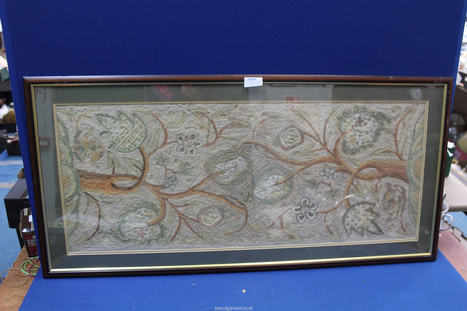 A floral Crewelwork, 37" x 17 3/4" including frame.