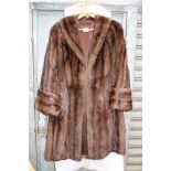 A ladies brown Mink coat with deep cuffs and side pockets.