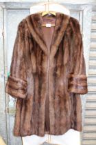 A ladies brown Mink coat with deep cuffs and side pockets.