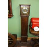 An Oak cased Grandmother Clock having a brass and silver face with Roman numerals,