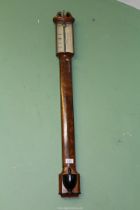 A bow fronted Mahogany cased Mercurial Stick Barometer having a swan-neck pediment,