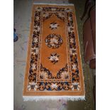 A soft Hearth rug in mustard with blue and white floral and border detail.