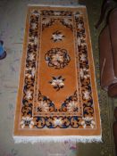 A soft Hearth rug in mustard with blue and white floral and border detail.