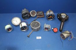 A tray of vintage car dashboard instruments to include; speedometer, Bakelite Ford clock,