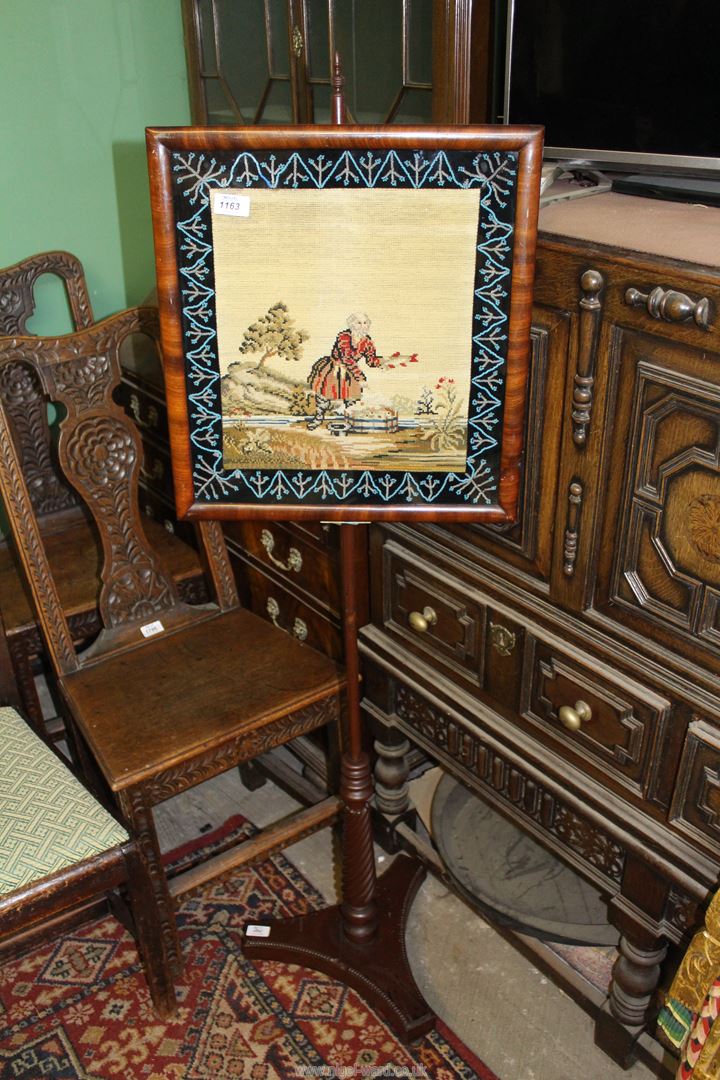 A Regency period, circa 1820, needle point tapestry Firescreen with beaded decoration to border.