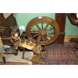 A nice quality reproduction Spinning Wheel with sign of recent used and complete with a book on