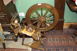 A nice quality reproduction Spinning Wheel with sign of recent used and complete with a book on