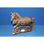 A carved wood figure of an Oriental style horse, 11" high.