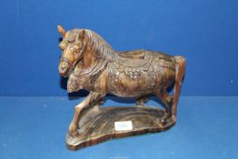 A carved wood figure of an Oriental style horse, 11" high.
