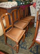 A set of four Oak framed Dining Chairs having angular shaped backrests,