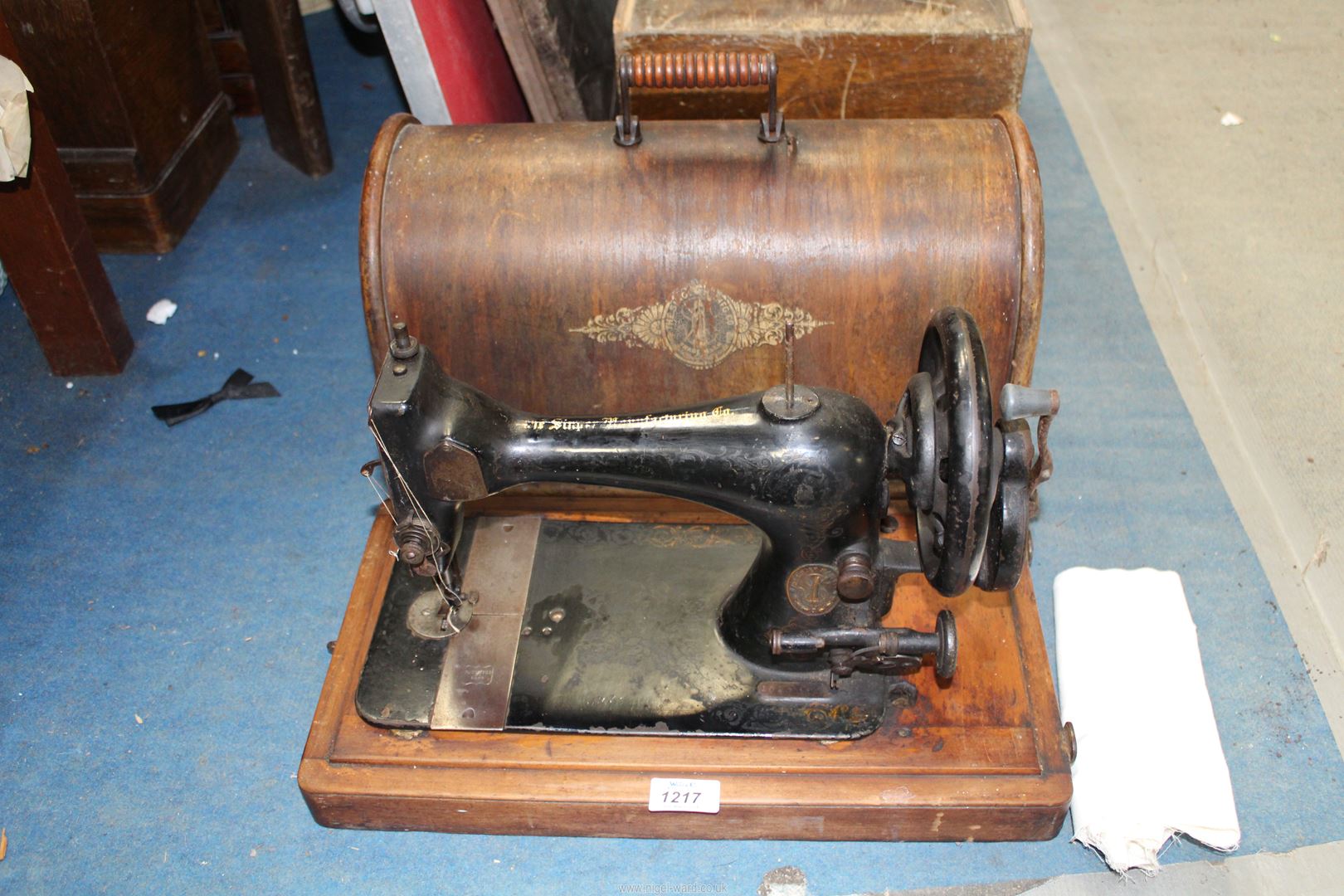 A hand Singer sewing machine in bentwood case.