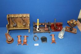 A tray containing four pipe racks, six single pipe stands and a mix of briar and meerschaum pipes,