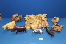 A quantity of wooden pigs including root carvings, tea light holders,