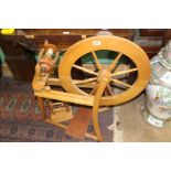 A lightwood spinning wheel.