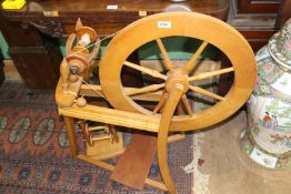 A lightwood spinning wheel.