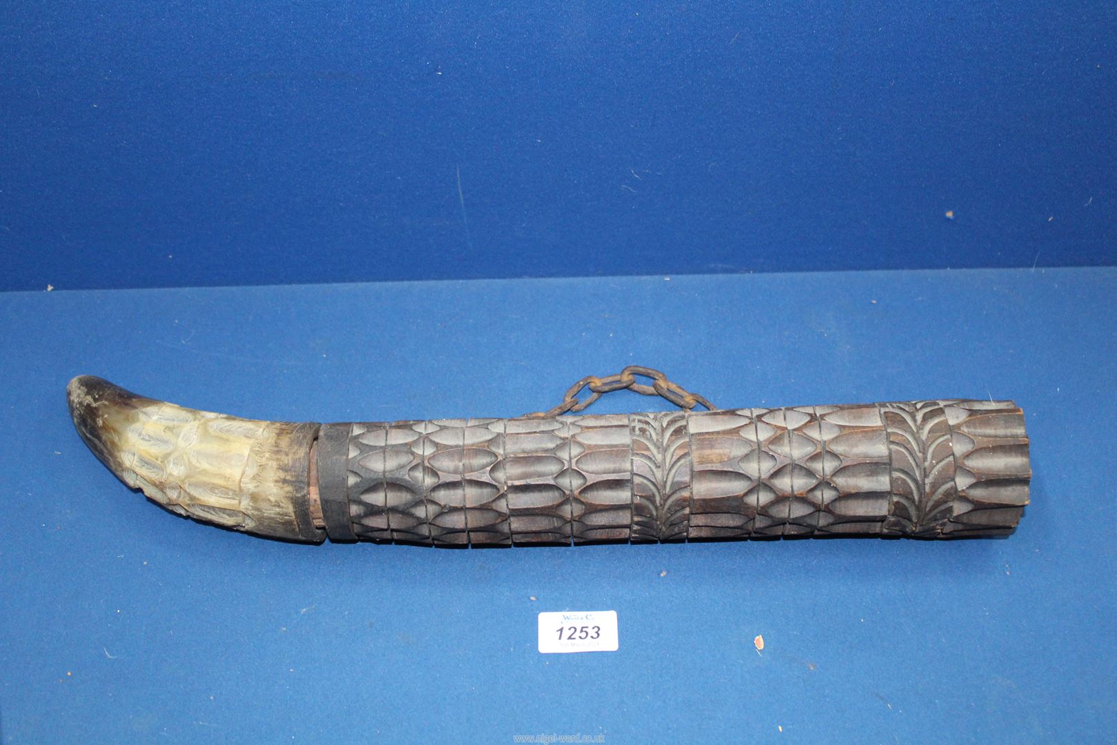 An African carved hardwood wind instrument with horn.