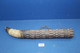 An African carved hardwood wind instrument with horn.