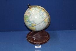 A Chad Valley tin plate Clock in form of a globe, 11" tall.