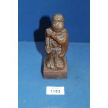 An early Chinese woodcarving of a flautist, probably Ming dynasty, 6'' tall.