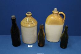 Three Victorian bottles and two earthenware bottles, one marked 'T.H.