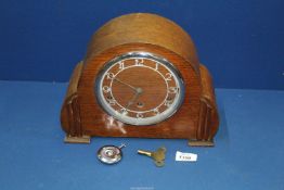A three train Westminster chiming Clock with pendulum and key.