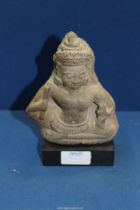 A Khmer stone figure of demon guardian,