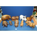 A large quantity of wooden Pig ornaments including one white painted.