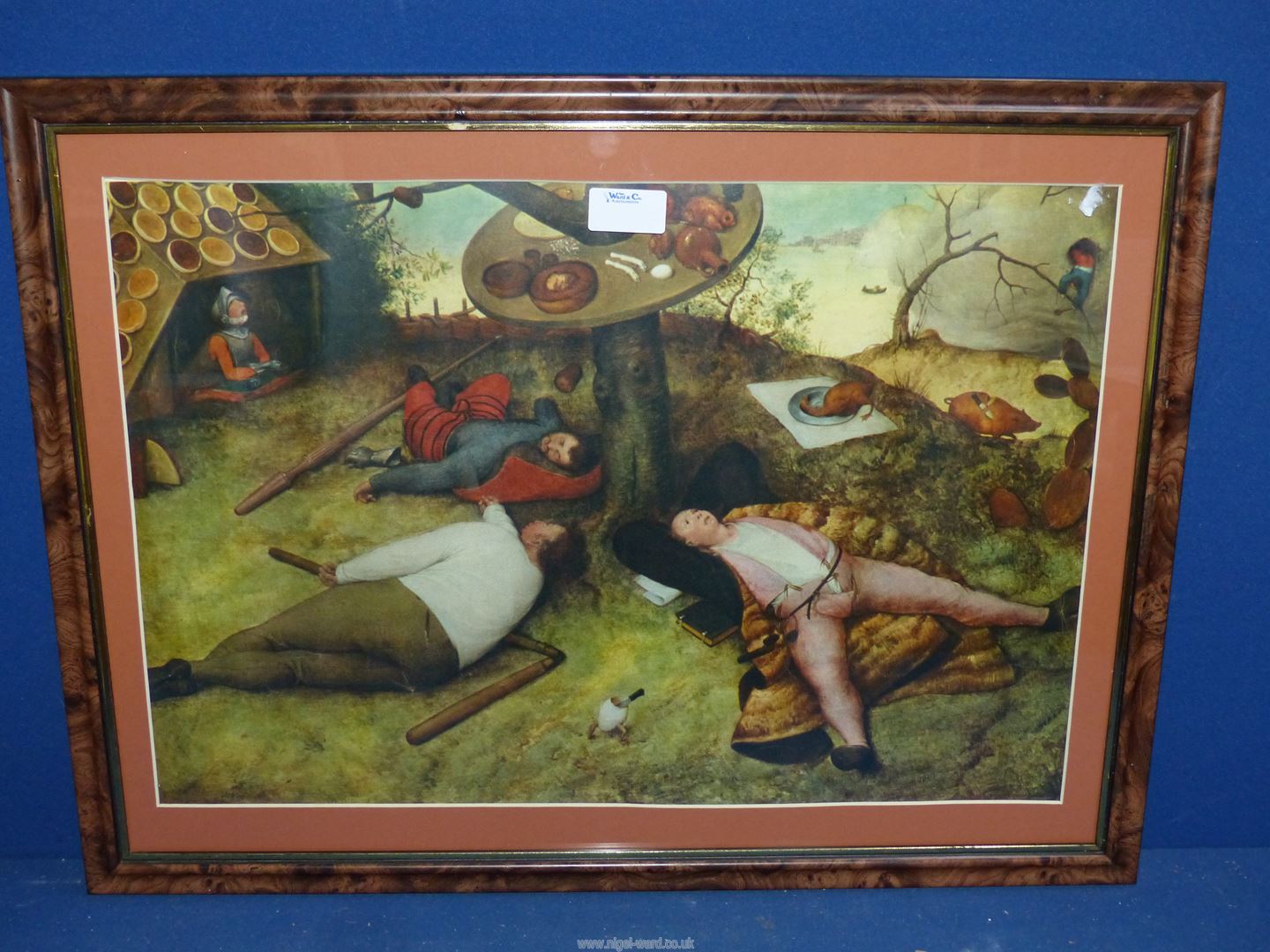 A framed Print by Pieter Bruegel 'The Elder of The Land of Cockaigne'.