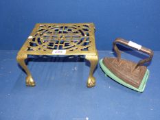 A vintage Smoothing Iron with green metal stand and a brass pot stand with decorative scrolling