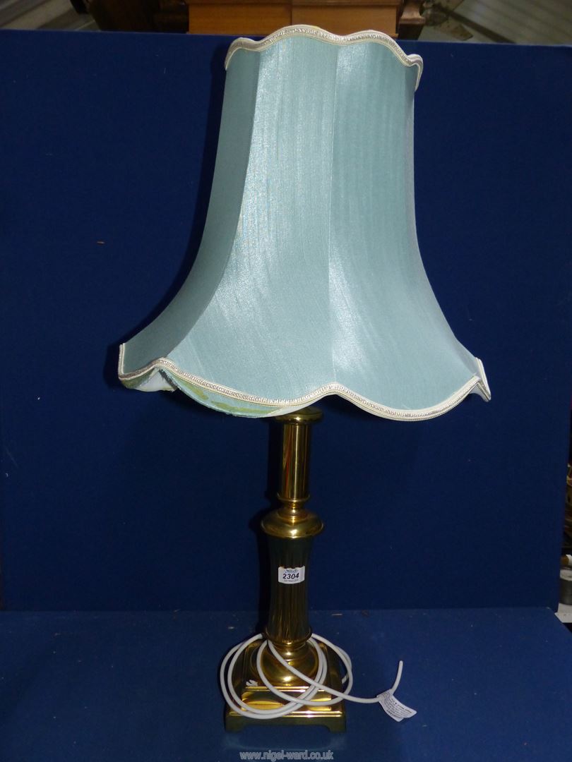 A brass table lamp, square based with duck egg blue shade, 20" tall excluding bulb and shade.