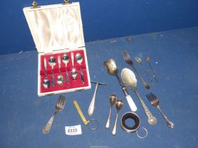 A small quantity of plated cutlery including cased set of teaspoons and a silver dessert fork,