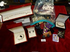 A quantity of costume jewellery including boxed bangles, clip-on earrings, beaded necklaces, etc.