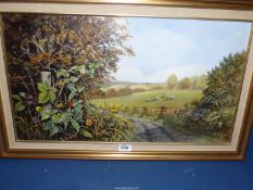 A framed oil on board titled verso 'September walk' depicting fields of sheep with hedgerow in the