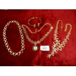 Three costume jewellery necklaces and a bracelet.