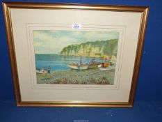 A framed and mounted Watercolour depicting a coastal scene with fishing boats and figures,