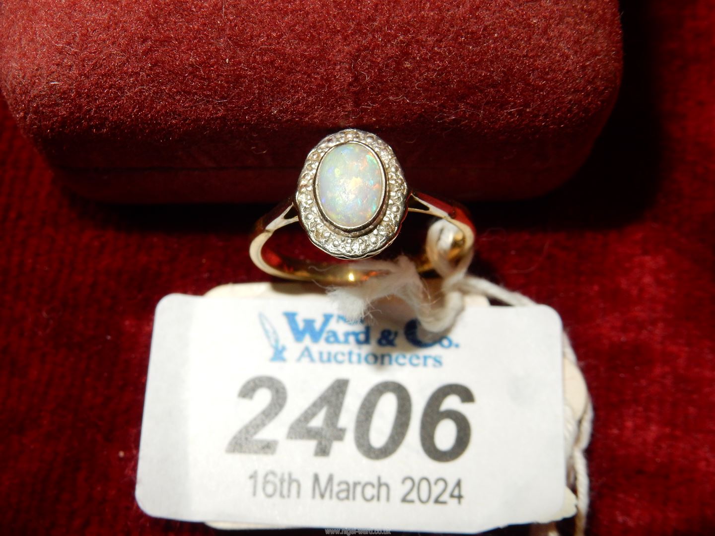 An 18ct gold Engagement ring set with a cabochon Opal surrounded by eight chip diamonds. - Image 2 of 3