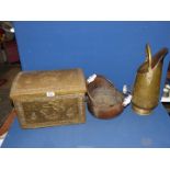 A brass coal scuttle and a copper scuttle with ceramic handles and an embossed brass coal box.