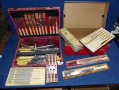 A quantity of boxed cutlery including bread knives, etc.