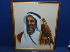 A framed oil on canvas depicting an Arab gentleman with a falcon, 21" x 24 1/2".
