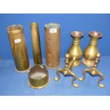 A quantity of brass including vases, fire dogs and shell cases.