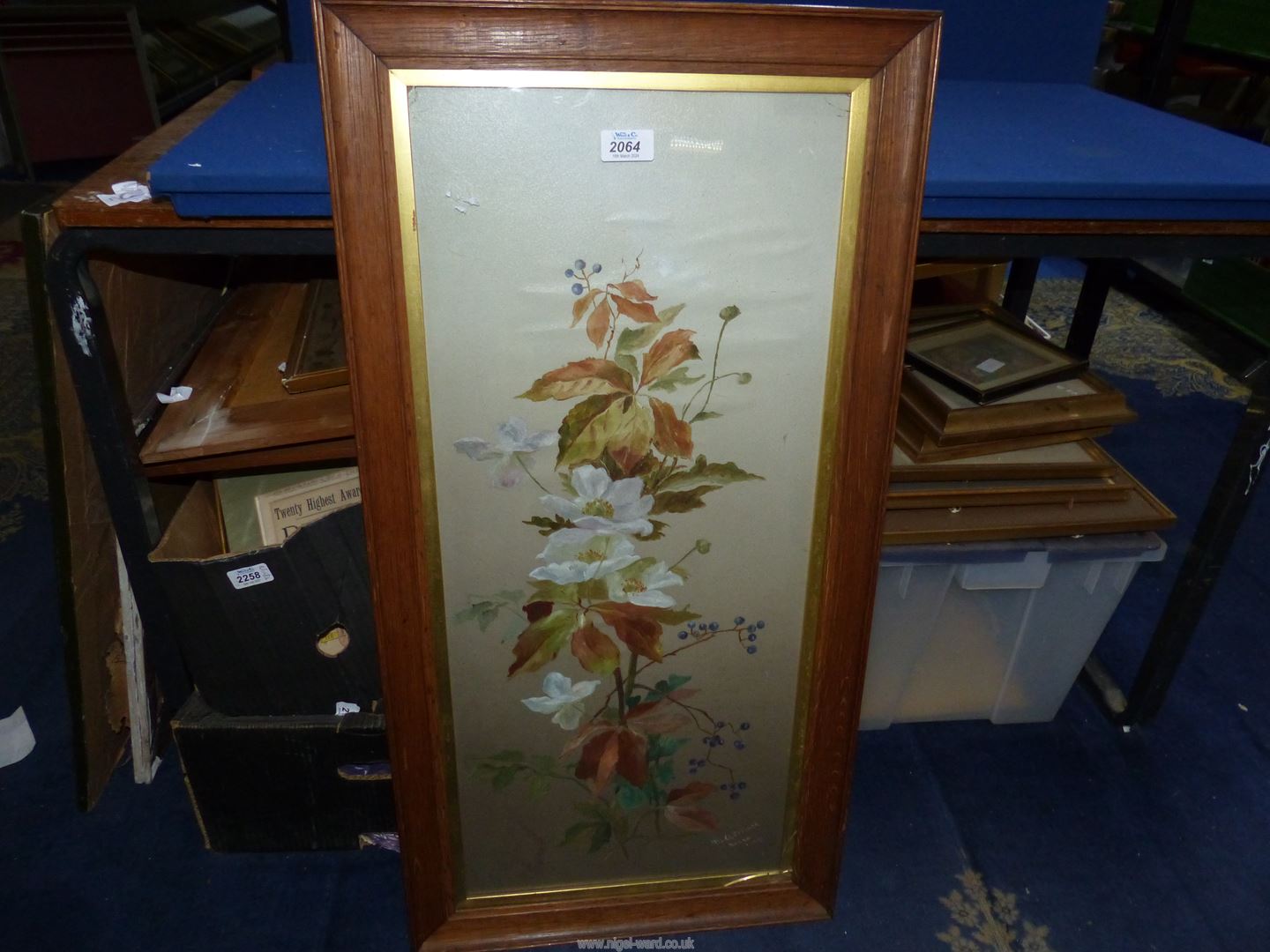 A wooden framed Watercolour depicting flowers, signed lower right (M.O. Elliott), 17" x 34".