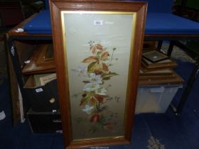 A wooden framed Watercolour depicting flowers, signed lower right (M.O. Elliott), 17" x 34".