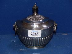 A Silver lidded Sucrier in half ribbed pattern with wooden finial and having lion mask drop handles,