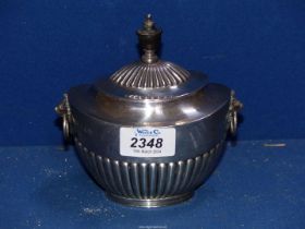 A Silver lidded Sucrier in half ribbed pattern with wooden finial and having lion mask drop handles,