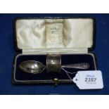 A Silver cased Spoon and napkin ring set, London 1921, makers Bell Brothers, Doncaster, 39.2g.