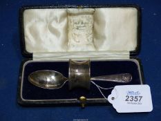 A Silver cased Spoon and napkin ring set, London 1921, makers Bell Brothers, Doncaster, 39.2g.