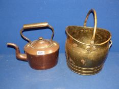 A small brass coal bucket and a copper kettle.