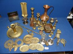 A box of brass and copper including copper jug, small candlesticks, horse brasses, etc.