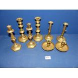 A small quantity of pairs of brass candlesticks and a pair of chamersticks.