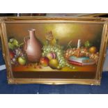 A large framed Oil on board of a still life, fruit, candle, books,